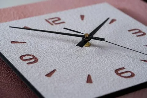 Close-up of pointer clock on wood grain stone texture surface Stock Photos