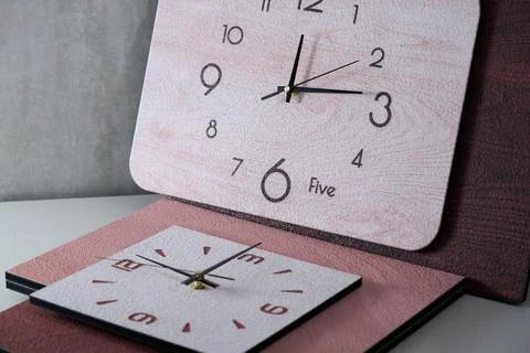 Close-up of pointer clock on wood grain stone texture surface Stock Photos