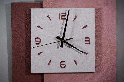 Close-up of pointer clock on wood grain stone texture surface Stock Photos