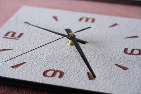 Close-up of pointer clock on wood grain stone texture surface Stock Photos