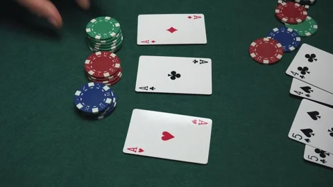 Close-up of poker game showing hands placing chips on table with playing cards 動画素材 337925546