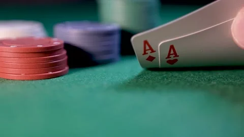 Close up of poker player checking cards, holding two aces Stock Footage 281446188