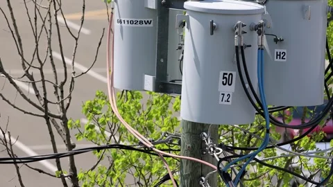 Close-Up of Pole-Mounted Electric Transformers and Power Lines Stock Footage 330196576