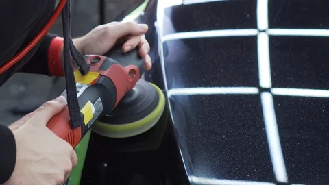 Close-up of a polished surface of a car with glare of ceiling neon lamps on it Stock Footage 115932447