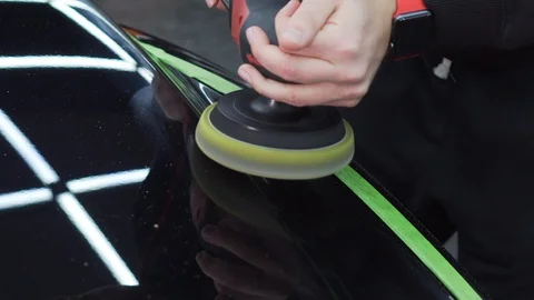 Close-up of a polished surface of a car with glare of ceiling neon lamps on it Stock Footage 115933793