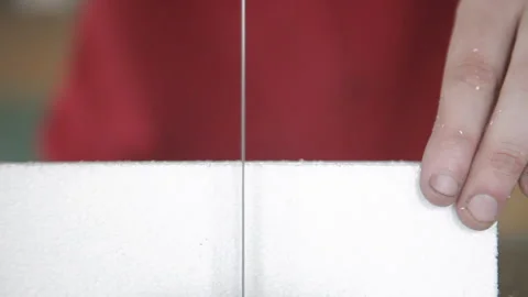 Close up of polystyrene cut off by a jigsaw Stock Footage 231497175