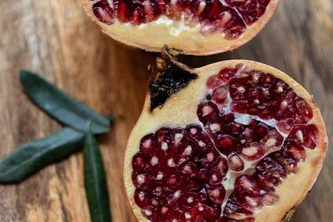 Close-up of a pomegranate opened on a table Stock Photos