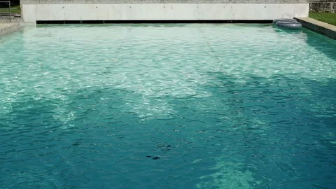 Close up of pool with inflatable rubber lounger on water surface in slow motion Stock Footage 128966141