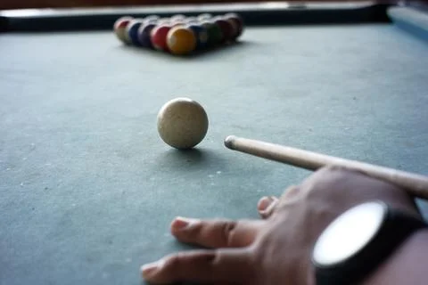 Close up of the pool player's hand preparing to start the game Stock Photos