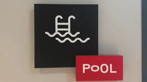 Close-up of “Pool” sign with swimming pool icon Stock Footage 312097259