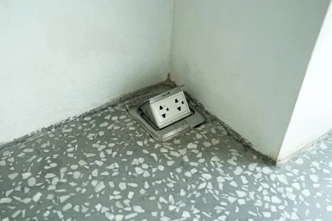 Close up Pop up electrical floor plug outlet on the marbled floor Stock-Fotos