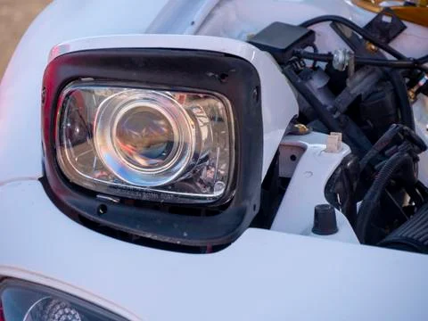 Close Up of Pop-Up Headlight on White Car Stock Photos