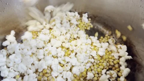 Close-up of popcorn kernels popping in a hot pot Video stock 293956930