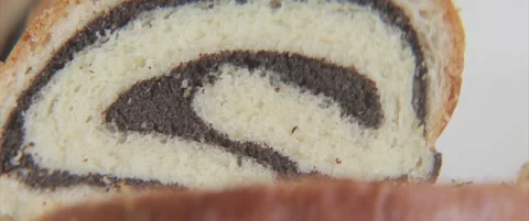 Close-up of poppy seed roll slice 4K anamorphic video Stock Footage 320519774