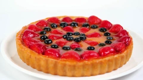 A close-up of a popular dessert on a white background. Cheesecake with strawberr Stock Footage 282963146
