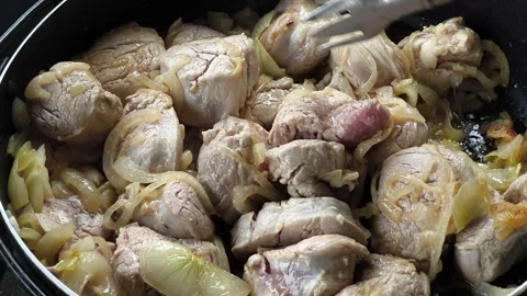 Close-up of pork and onions braised in a rich soy sauce mixture. Stock Footage 337332859