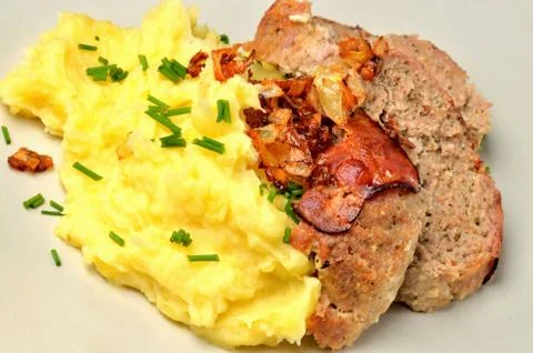 Close-up of pork chop with mashed potatoes, bacon and fresh chives Stock Photos