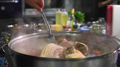 Close-up of pork knuckle with vegetables cooked in boiling water Stock Footage 267282772