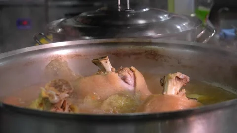 Close-up of pork knuckle with vegetables cooked in boiling water Stock Footage 267289970