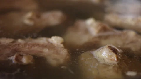 Close-Up of Pork Ribs Boiling in Broth in Kitchen Pot 스톡 동영상 334124022