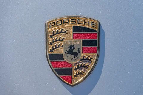 Close-up of a Porsche emblem, circular with central shield bearing a stylized Stock Photos
