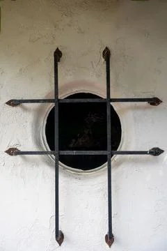 Close up on a port hole with metal security bars. Stock Photos
