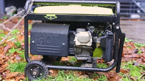 Close-up of portable power generator engine on wet ground Stock Footage 321803373