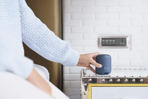 Close-up on portable wireless speaker in hand on table, new tech Stock Photos