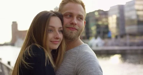 Close portrailt of romantic couple hugging in sunset Stock Footage 83376868