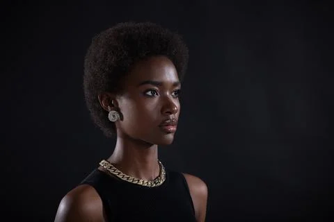 Close up portrait of african american woman with afro hairstyle on black studio Stock Photos