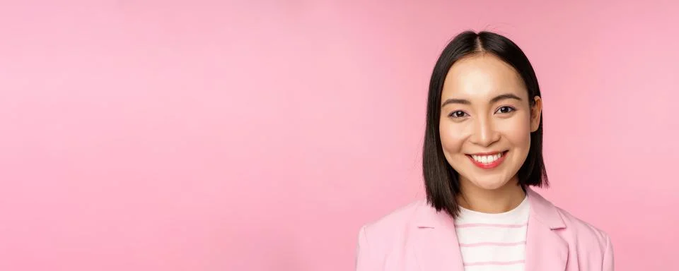 Close up portrait of asian corporate woman, looking professional, smiling at Stock Photos