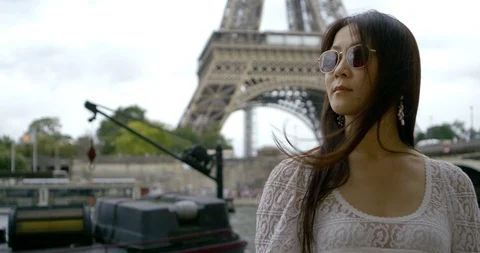 Close-up portrait of an Asian middle-aged woman who is in Paris against the Stock Footage 113940547