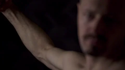 Close-up portrait of an athletic man against a dark background Stock Footage 319702883
