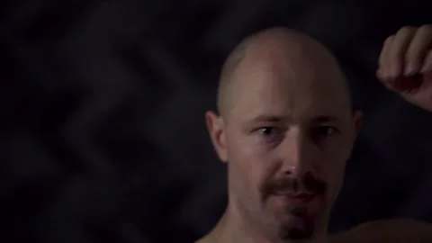 Close-up portrait of an athletic man against a dark background Video stock 319704594