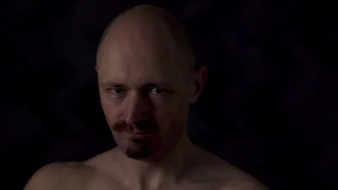 Close-up portrait of an athletic man against a dark background Stock Footage 319705216