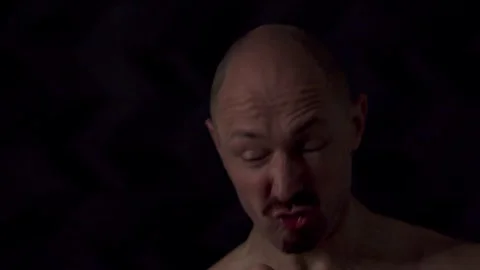 Close-up portrait of an athletic man against a dark background Video stock 319705331