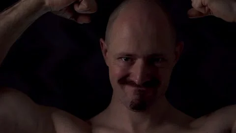 Close-up portrait of an athletic man against a dark background Stock Footage 319707178