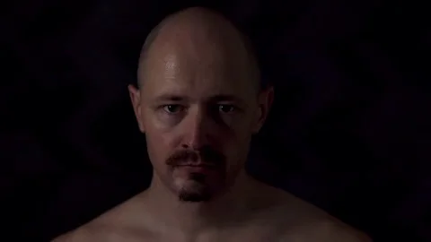Close-up portrait of an athletic man against a dark background Stock Footage 319708587