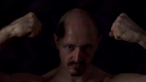 Close-up portrait of an athletic man against a dark background Video stock 319708672