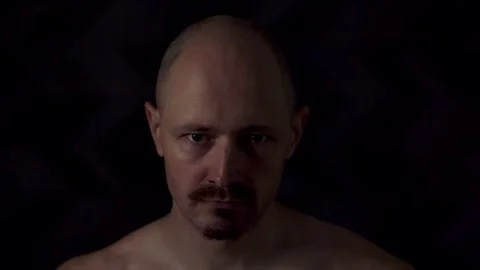 Close-up portrait of an athletic man against a dark background Stock Footage 319709258