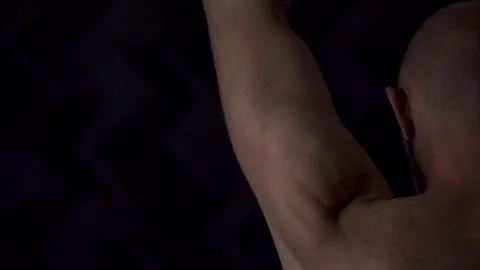 Close-up portrait of an athletic man against a dark background Stock Footage 319709942