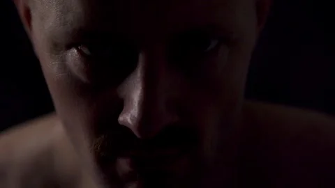 Close-up portrait of an athletic man against a dark background Stock Footage 319711277