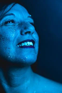 Close-up portrait of attractive middle-aged woman with colorful beads on her Foto stock