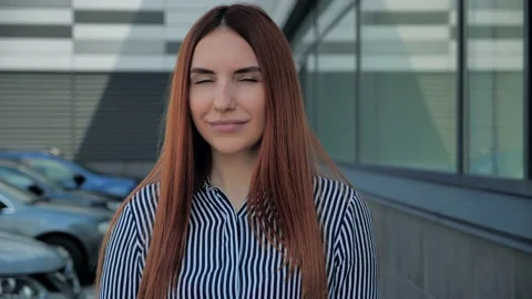Close up portrait of an attractive red-haired woman opening her green eyes Stock Footage 135256324