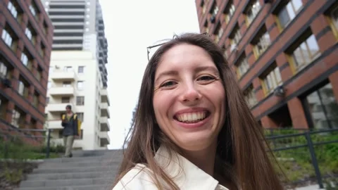 Close-up portrait of attractive young Caucasian girl smiling and looking at Stock Footage 310036352