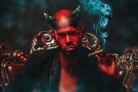 A close-up portrait of a bad demon with a cigar. Horror movie, nightmare. Hal Stock Photos