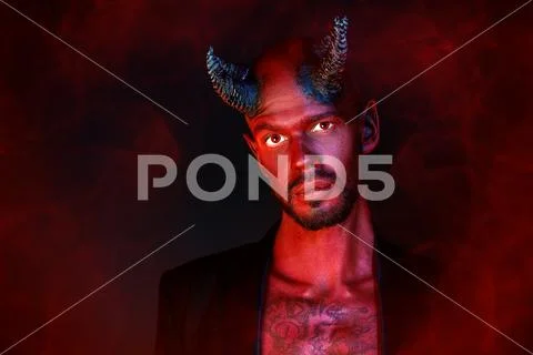 A close-up portrait of a bad demon. Horror movie, nightmare. Halloween. Stock Photos