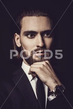 Close-up portrait of a bearded handsome young man in elegant clothes. Male be Stock Photos