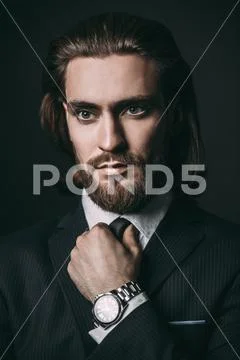 Close-up portrait of a bearded handsome young man in elegant clothes. Male be Stock Photos