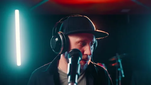 Close up portrait of bearded man in cap with headphones in recording studio Stock Footage 286157950